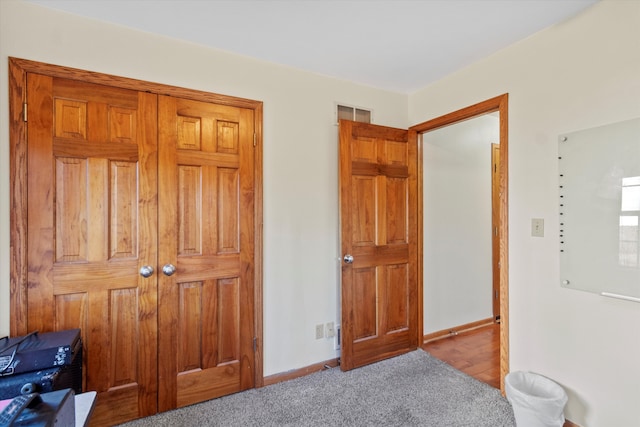 carpeted bedroom featuring visible vents and baseboards