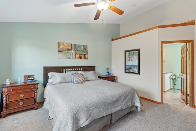 bedroom with baseboards, connected bathroom, ceiling fan, carpet, and vaulted ceiling