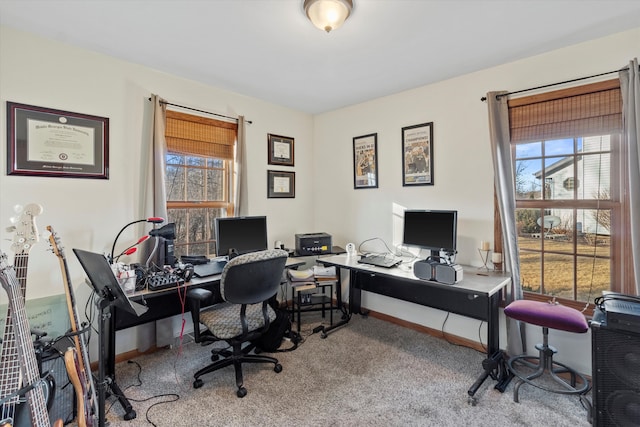 carpeted office space with a wealth of natural light and baseboards