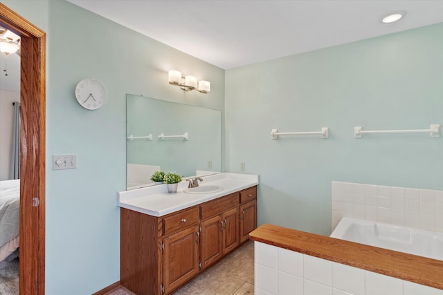 ensuite bathroom featuring a garden tub, connected bathroom, and vanity