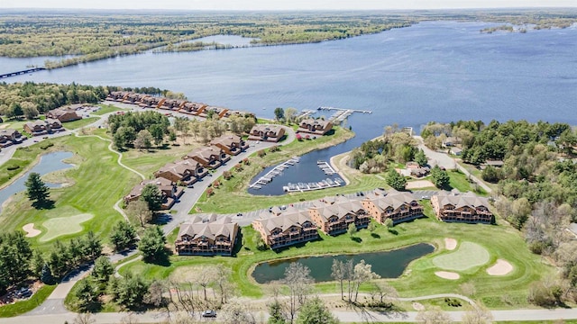 birds eye view of property with golf course view, a water view, and a residential view