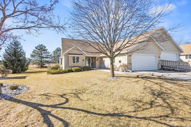 view of front of property featuring a front yard, concrete driveway, and an attached garage