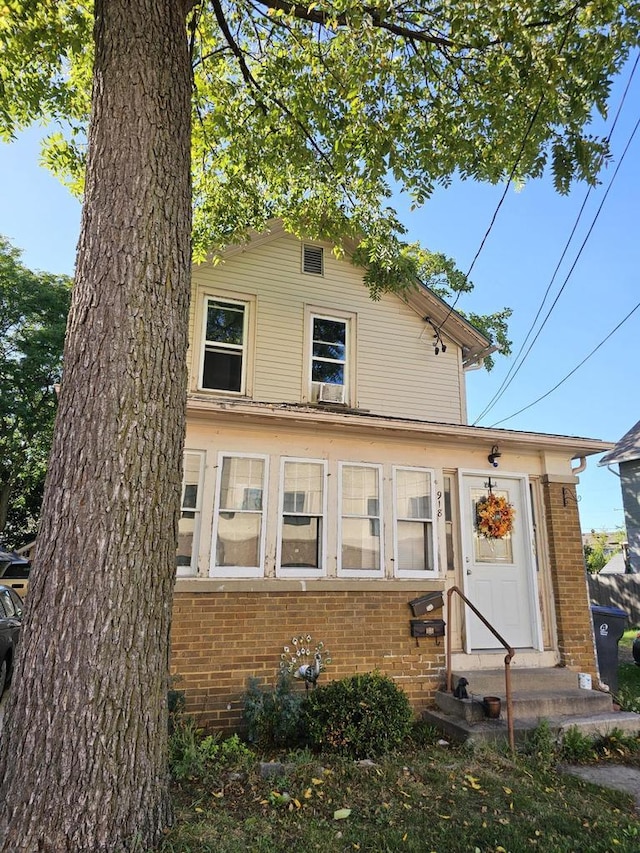 view of front of property with entry steps and brick siding