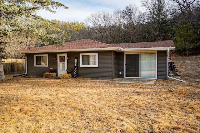 ranch-style home featuring roof with shingles