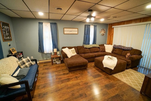 living area featuring a paneled ceiling, wood finished floors, and visible vents