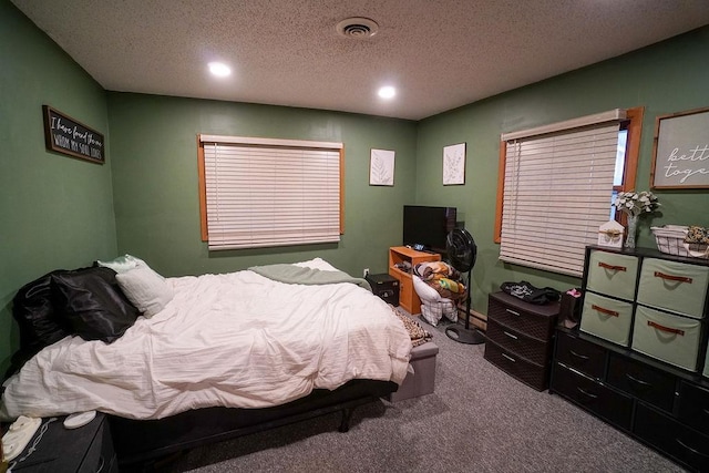 bedroom with a textured ceiling, carpet floors, visible vents, and recessed lighting