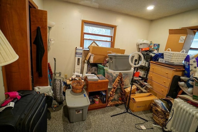 misc room with a textured ceiling, recessed lighting, carpet flooring, and radiator