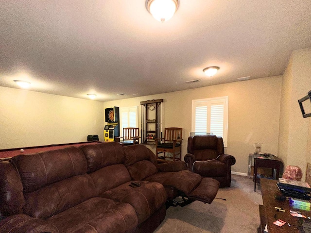 carpeted living area with visible vents and a textured ceiling