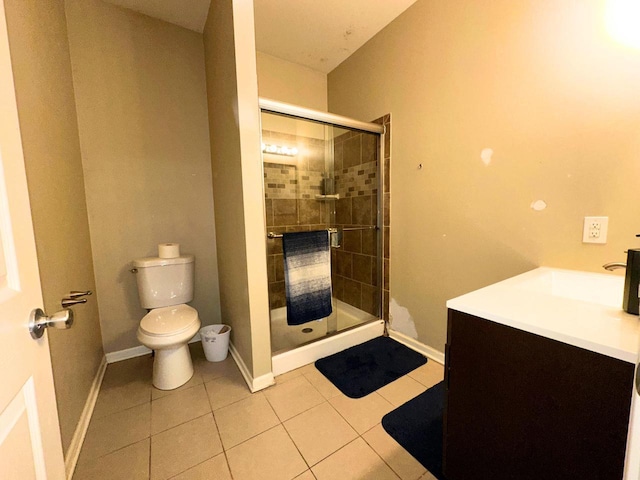 bathroom featuring baseboards, toilet, a stall shower, and tile patterned flooring