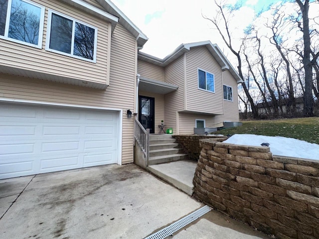 view of front facade featuring concrete driveway and a garage