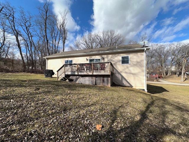 rear view of house featuring a yard and a wooden deck