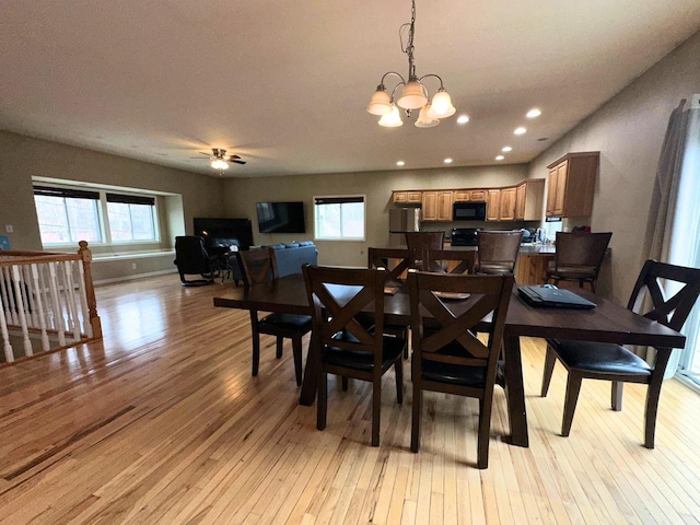 dining area with ceiling fan with notable chandelier, recessed lighting, and light wood-style floors