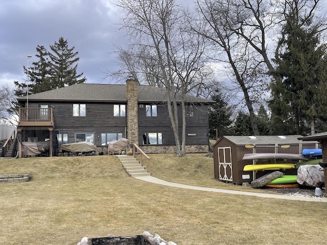 view of front facade featuring a storage unit, a lawn, an outdoor structure, and stairway