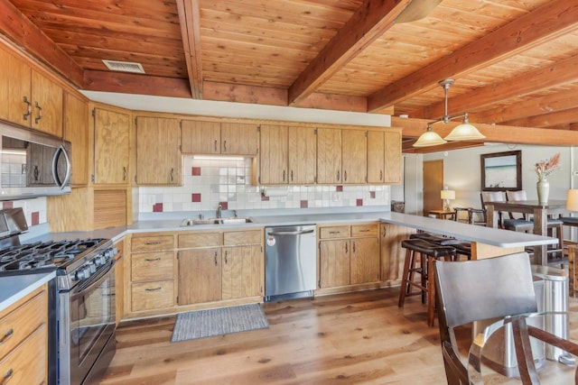 kitchen featuring backsplash, visible vents, appliances with stainless steel finishes, and a sink