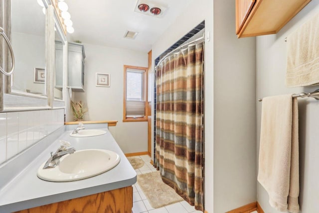 full bath featuring tile patterned flooring, a shower with shower curtain, visible vents, and a sink