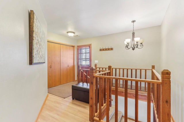 foyer with an inviting chandelier and wood finished floors