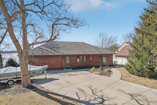 view of front of property with a garage, roof with shingles, and fence