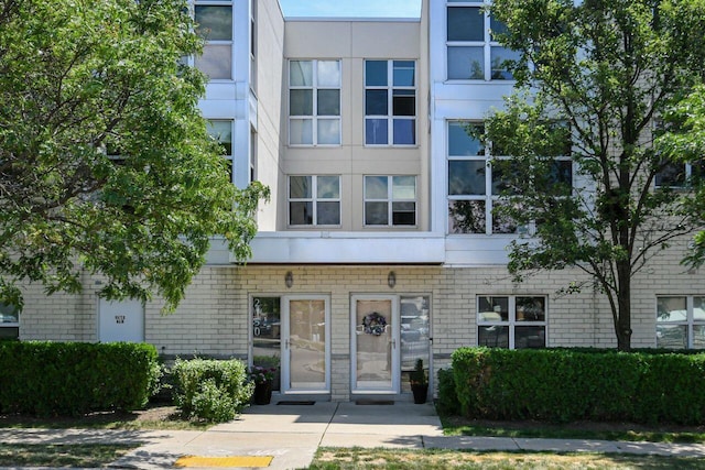 view of property with brick siding and stucco siding