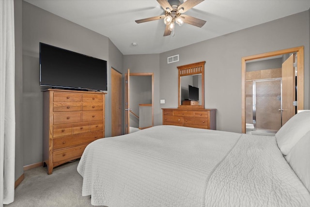 carpeted bedroom featuring visible vents, ceiling fan, ensuite bathroom, and baseboards