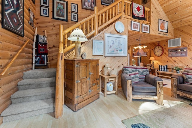 staircase featuring visible vents, wooden ceiling, wood finished floors, log walls, and high vaulted ceiling