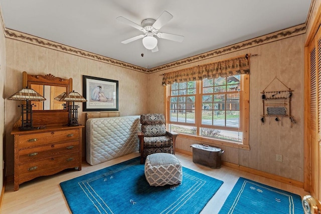 sitting room with ceiling fan, light wood-style flooring, and baseboards