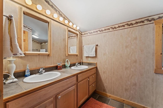 full bathroom with double vanity, a sink, and tile patterned floors