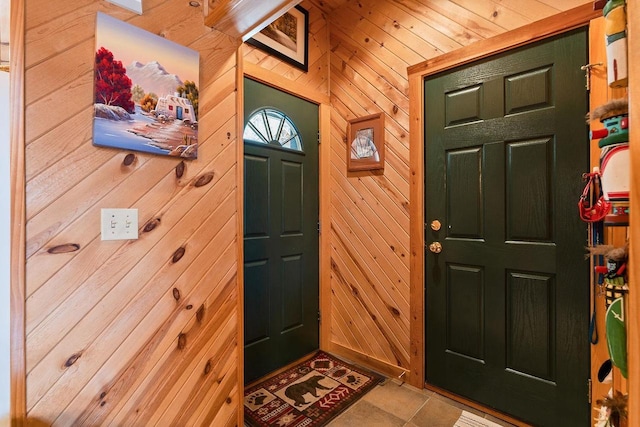 foyer entrance featuring wood walls