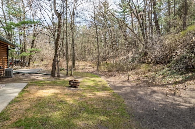 view of yard featuring a fire pit and cooling unit