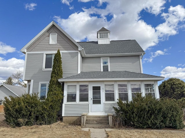 view of front of home featuring a shingled roof and entry steps