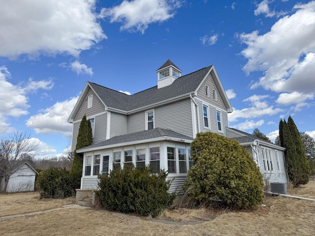 view of home's exterior with a shingled roof