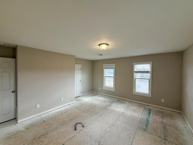 spare room featuring baseboards