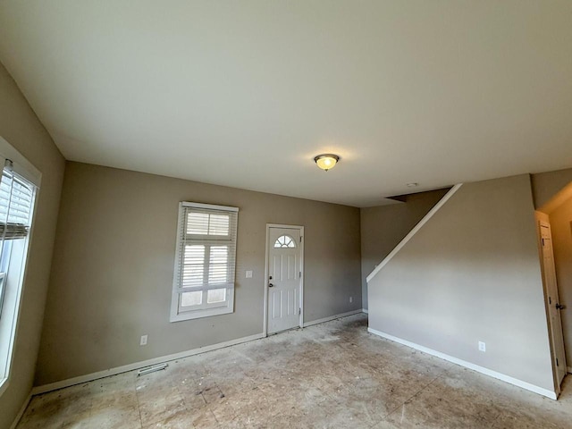 entrance foyer featuring visible vents, baseboards, and stairs