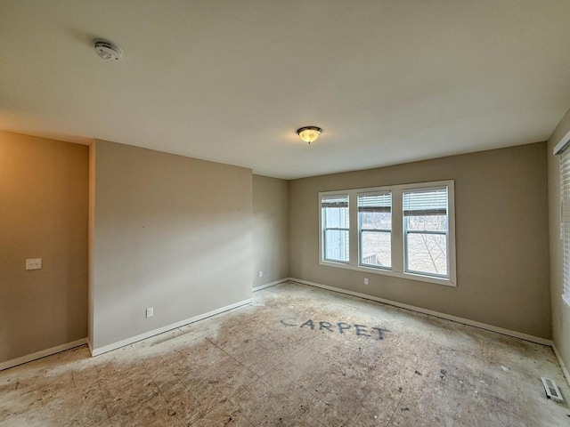 empty room featuring visible vents and baseboards