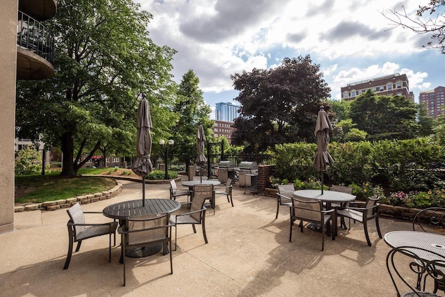 view of patio / terrace with a view of city and outdoor dining area