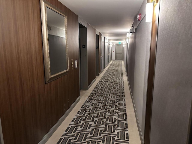 hall with light carpet and baseboards