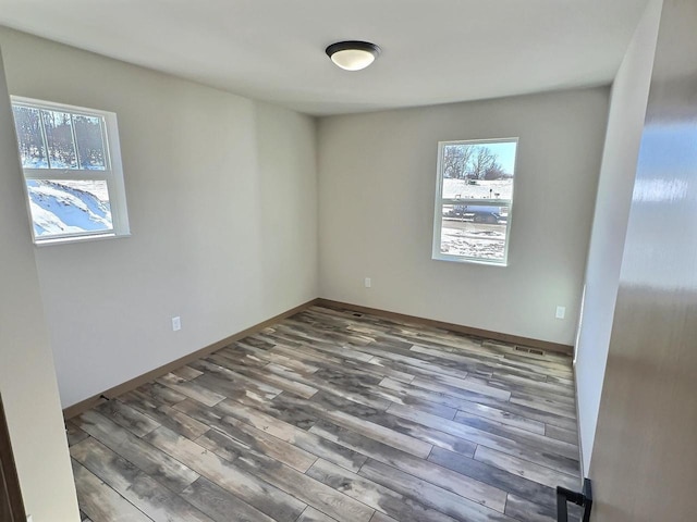 empty room with wood finished floors and baseboards