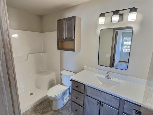 full bath with a shower, vanity, toilet, and tile patterned floors