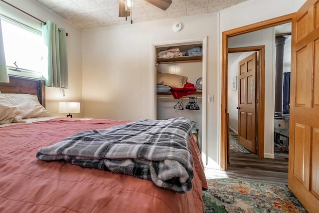 bedroom featuring a ceiling fan, a closet, and wood finished floors