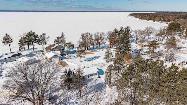 snowy aerial view with a water view