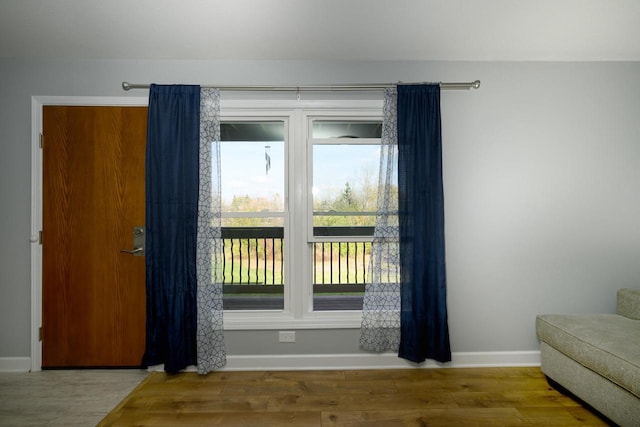 interior space featuring wood finished floors and baseboards