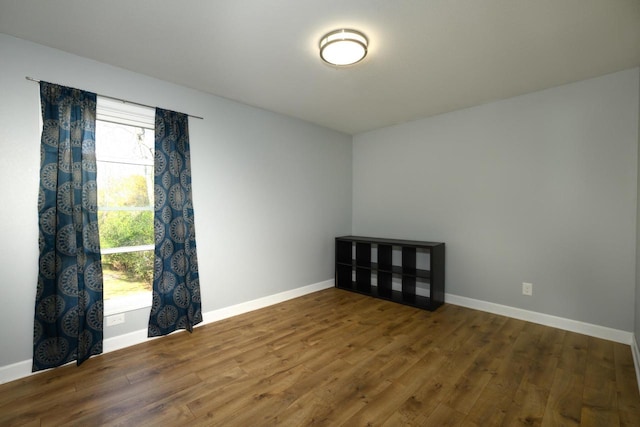 empty room with wood finished floors and baseboards