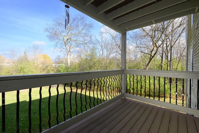 wooden terrace featuring a lawn