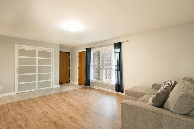 living room with baseboards and wood finished floors