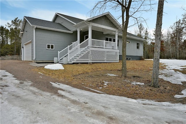 view of front of house featuring covered porch and an attached garage