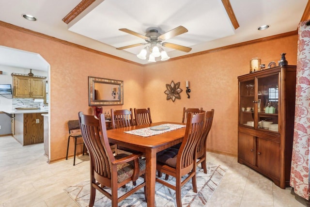 dining area with ornamental molding, baseboards, and a ceiling fan