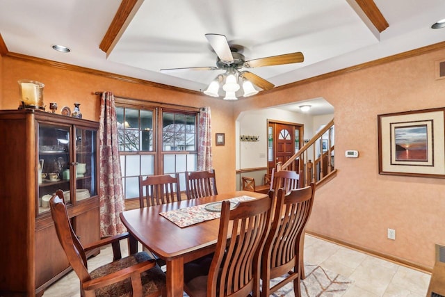 dining room featuring visible vents, stairway, ornamental molding, a ceiling fan, and baseboards