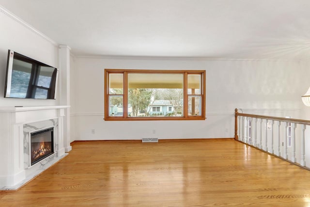 442 Forest Dr, Fontana, WI 53125 - unfurnished living room featuring wood finished floors, a fireplace, ornamental molding, and baseboards