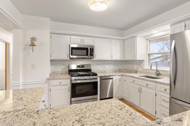 442 Forest Dr, Fontana, WI 53125 - kitchen featuring stainless steel appliances, a sink, and light stone counters