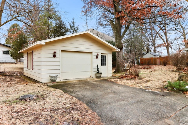 442 Forest Dr, Fontana, WI 53125 - view of home's exterior featuring an outdoor structure, driveway, and a detached garage