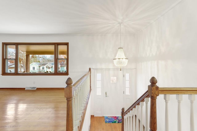 442 Forest Dr, Fontana, WI 53125 - foyer entrance featuring wood finished floors, a chandelier, and baseboards